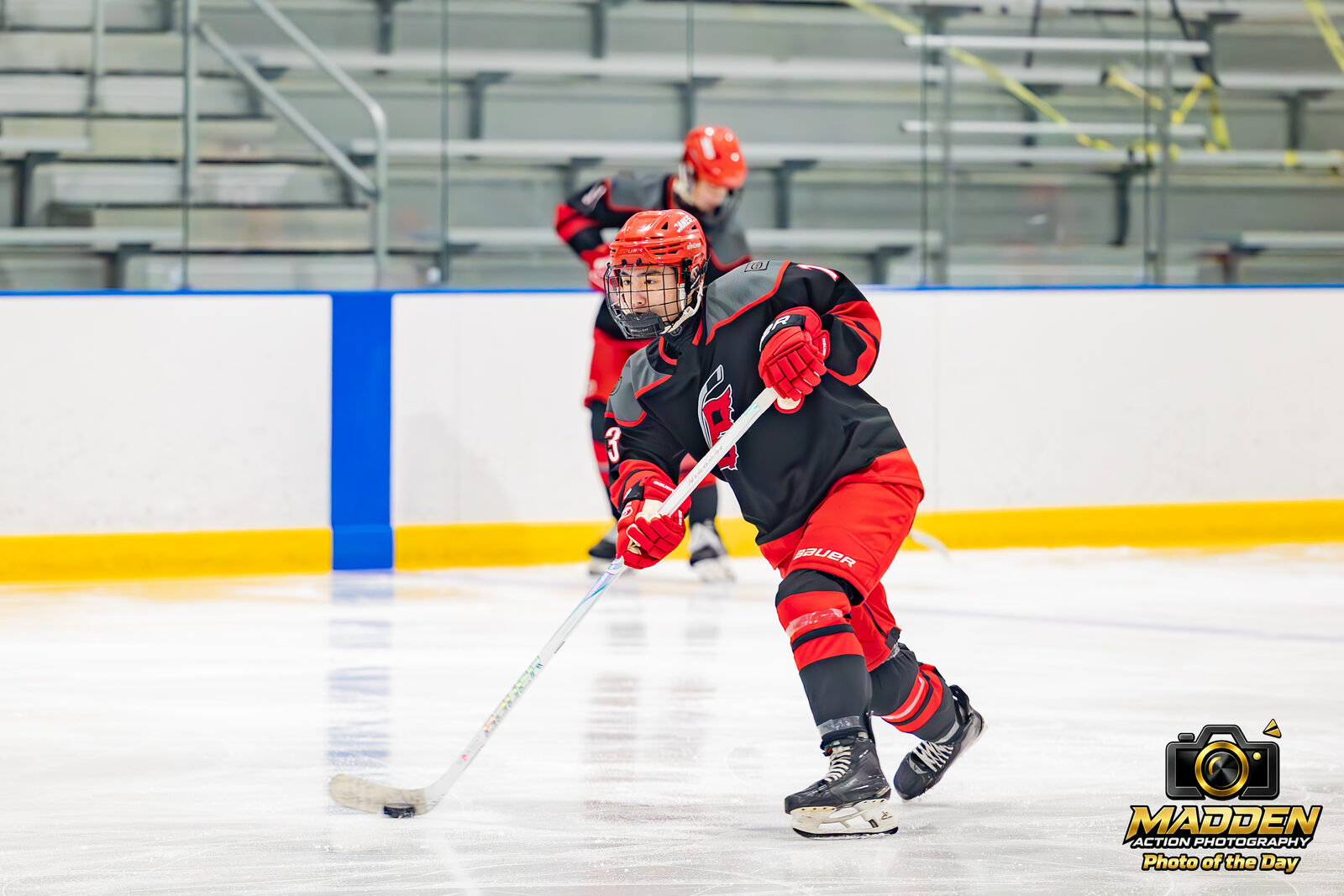 Youth hockey player skating with the puck